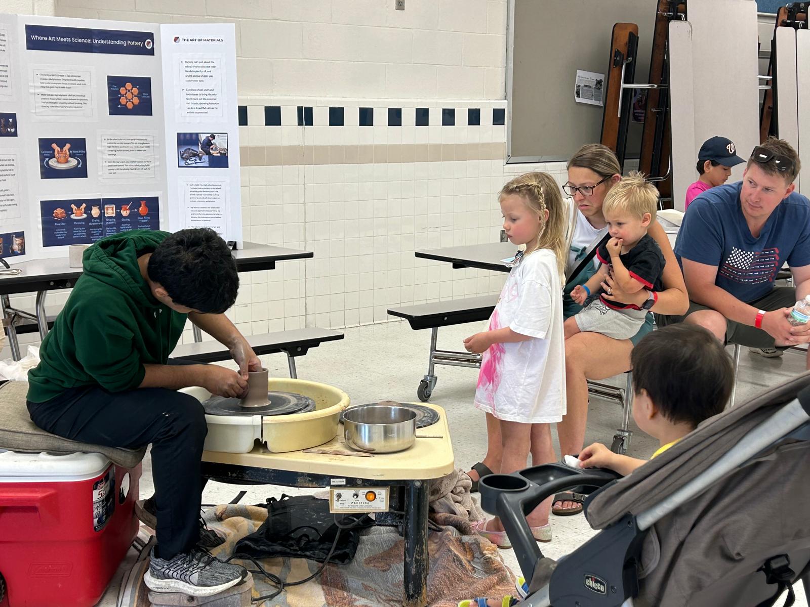 A pottery wheel station at a school district summer event